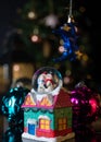 Christmas scene with tree, lights and snow globe. Selective focus on black background Royalty Free Stock Photo