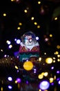 Christmas scene with tree, lights and snow globe. Selective focus on black background Royalty Free Stock Photo