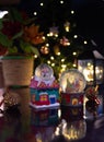 Christmas scene with tree, lights and snow globe. Selective focus on black background Royalty Free Stock Photo