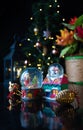 Christmas scene with tree, lights and snow globe. Selective focus on black background Royalty Free Stock Photo