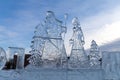 Christmas sculpture of Father Frost and the Snow Maiden, carved out of ice, stands outside against the sky