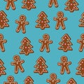 Christmas seamless pattern. Brown gingerbread man and Christmas Tree cookies on blue background Royalty Free Stock Photo