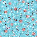 Christmas seamless pattern with candy canes, lollipops, snowflakes, snow ball on blue background. Design for wrapping Royalty Free Stock Photo