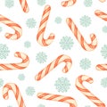 Christmas seamless pattern with candy canes and snowflakes. Red and white striped candy canes and blue snowflakes on a white Royalty Free Stock Photo