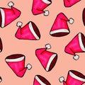 Christmas seamless pattern drawn by hand. Red Santa Claus hat on a pink background. Happy New Year