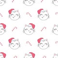 Christmas seamless pattern with the image of little cute kittens in the hat of Santa Claus. Royalty Free Stock Photo