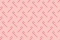 Christmas seamless pattern made of striped candy cane on a pink pastel background. Background made of food. Christmas and New year Royalty Free Stock Photo