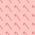 Christmas seamless pattern made of striped candy cane on a pink pastel background. Background made of food. Christmas and New year Royalty Free Stock Photo