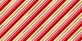 Christmas seamless pattern of red and white diagonal candy cane stripes or lines with shiny gold leaf foil background Royalty Free Stock Photo