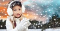 Happy little girl in earmuffs over winter forest Royalty Free Stock Photo