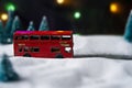 Christmas. Selective focus on red toy bus in blurred imitation winter background. Close up Royalty Free Stock Photo