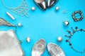 Christmas Set of fashion accessories flat lay shoes handbag necklace jewelry silver color on blue background Top view copy space Royalty Free Stock Photo