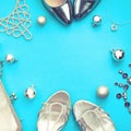 Christmas Set of fashion accessories flat lay shoes handbag necklace jewelry silver color on blue background Top view copy space Royalty Free Stock Photo