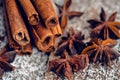 Christmas setting with bundle of cinnamon, anise stars and other christmas decorations on the rustic wooden background Royalty Free Stock Photo