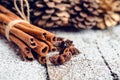 Christmas setting with bundle of cinnamon, anise stars and other christmas decorations on the rustic wooden background Royalty Free Stock Photo