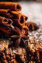 Christmas setting with bundle of cinnamon, anise stars and other christmas decorations on the rustic wooden background Royalty Free Stock Photo