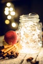 Christmas setting with bundle of cinnamon, jar with lights, anise stars and other christmas decorations Royalty Free Stock Photo