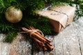 Christmas setting with bundle of cinnamon and pine branches on the rustic wooden background Royalty Free Stock Photo