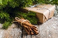 Christmas setting with bundle of cinnamon and pine branches on the rustic wooden background Royalty Free Stock Photo
