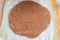 Christmas shaped gingerbread cookie from the raw dough before baking.