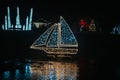 Christmas ship made of garlands in the dark.Christmas installations from garlands.Shimmering street scenery