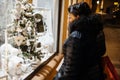 Christmas shop window admired by woman