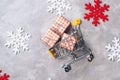 Christmas shopping. Shopping cart with Christmas gifts. Color snowflackes. Christmas sales. Happy New Year. Gifts and shopping Royalty Free Stock Photo