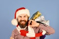 Christmas shopping concept. Guy or hipster shopper in red hat Royalty Free Stock Photo