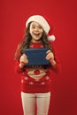 Christmas shopping. Happy winter holidays. Small girl. Little girl child in santa red hat. Have a holly jolly Christmas Royalty Free Stock Photo