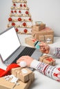Christmas shopping online. Unrecognizable Man Hands holding Credit Card buying presents by using laptop. Royalty Free Stock Photo