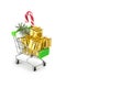 Christmas shopping season concept - mini shop cart trolley full of gift box isolated on white background. small grocery cart with Royalty Free Stock Photo