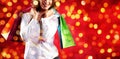 Christmas shopping, smiling woman with bags on blurred bright li Royalty Free Stock Photo