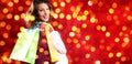 Christmas shopping, smiling woman with bags on blurred bright li Royalty Free Stock Photo