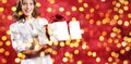 Christmas shopping, woman with gift package on blurred bright li