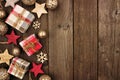 Christmas side border of gifts and rustic decorations on wood Royalty Free Stock Photo