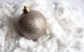 Christmas silver ball close-up in artificial snow. Christmas toy on a white background Royalty Free Stock Photo