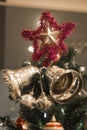 Christmas Silver bell and star hanging on a beautiful Chrismas t Royalty Free Stock Photo