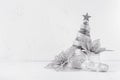 Christmas silver tree and decorations on white soft wood background. Festive interior. Royalty Free Stock Photo