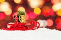 Christmas sleigh driving gold gift box and Xmas tree against abstract night bokeh light background Royalty Free Stock Photo