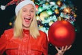 Christmas smiling woman. Christmas card. Beautiful female model wear santa hat. Close up portrait of happy young woman Royalty Free Stock Photo