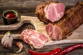 Christmas smoked ham under fir branch. Wooden background, copy space. farm organic food