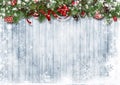 Christmas snow background with garland with candies, holly and branches