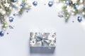 Christmas snow border gift box, shiny balls and stars, evergreen branches on a gray background. Christmas card
