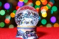 Christmas Snow Globe in front of Christmas tree lights closeup Royalty Free Stock Photo