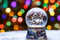 Christmas Snow Globe in front of Christmas tree lights closeup Royalty Free Stock Photo