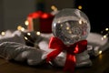 Christmas snow globe with knitting sweater on table. Space for text Royalty Free Stock Photo