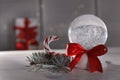 Christmas snow globe with red bow on table Royalty Free Stock Photo