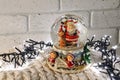 Christmas snow globe with santa claus inside and garland lights Royalty Free Stock Photo