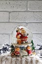 Christmas snow globe with santa claus inside and garland lights Royalty Free Stock Photo