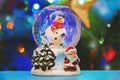 Christmas snow globe with Christmas tree lights background Royalty Free Stock Photo